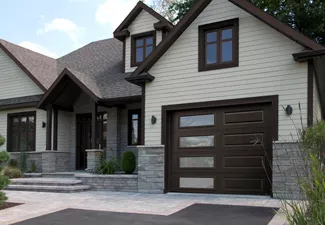 Maison avec une porte de garage et un cadrage en aluminium
